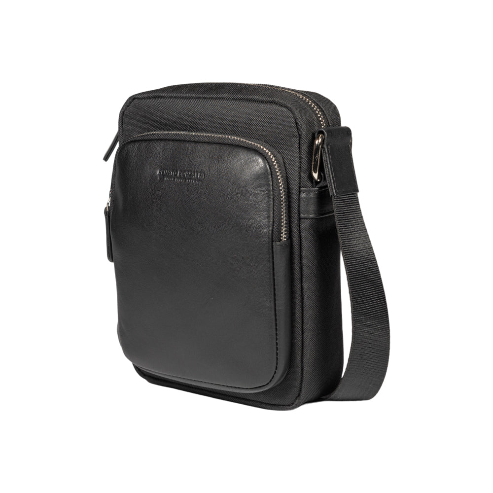 RB2002A | Nylon/Vera Leather Shoulder Bag, with light grain. Zipper closure and adjustable shoulder strap - Black color - Size: 15.5 x 21 x 7 cm. Packaging: Non-Woven Fabric Bag